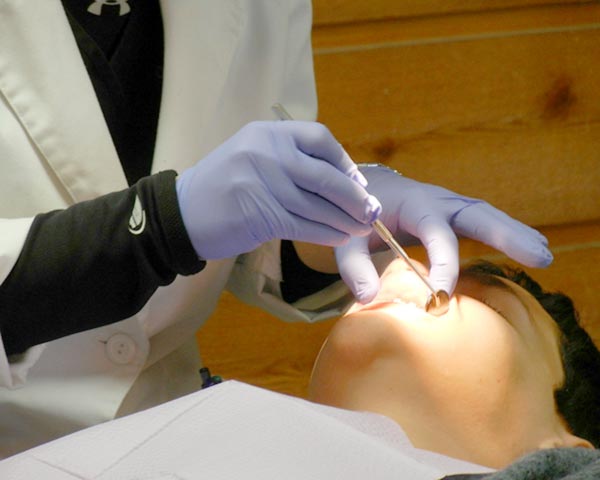 checking-teeth-with-mirror-dentist